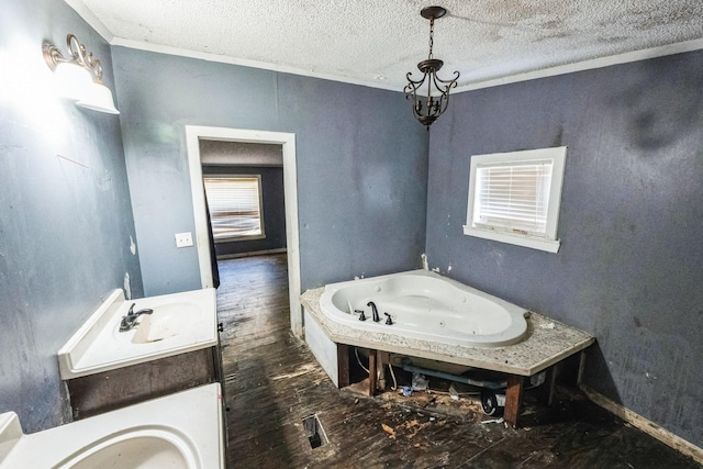 bathroom with a bathing tub, crown molding, wood-type flooring, and a textured ceiling