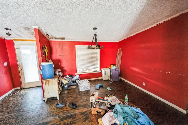 unfurnished dining area with vaulted ceiling, crown molding, and a textured ceiling