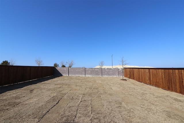 view of yard with a fenced backyard