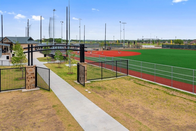 view of property's community featuring fence and a lawn