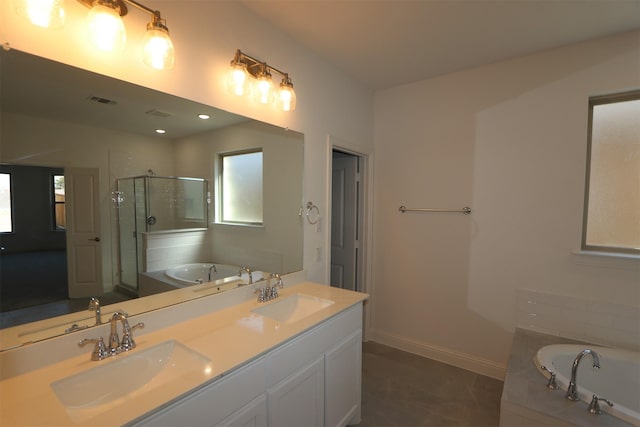 full bath featuring a bath, a shower stall, double vanity, and a sink