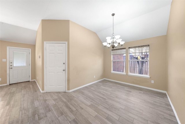 interior space with light hardwood / wood-style flooring, a chandelier, and vaulted ceiling