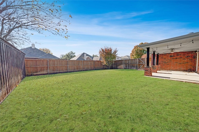 view of yard with ceiling fan