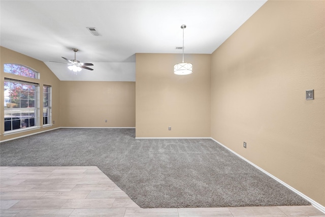 spare room featuring light carpet, ceiling fan, and lofted ceiling