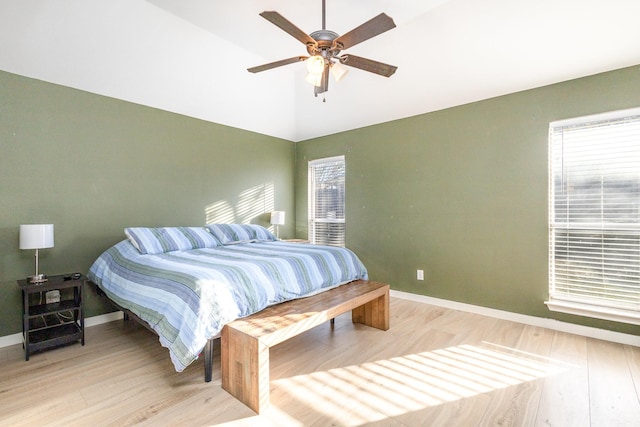 bedroom with multiple windows, ceiling fan, and light hardwood / wood-style floors