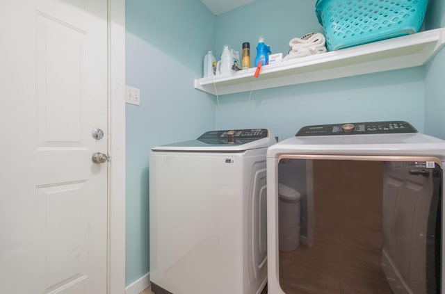 washroom with washer and clothes dryer and wood-type flooring