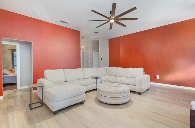 living room featuring light wood-type flooring and ceiling fan