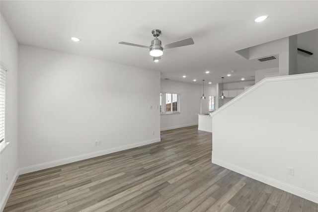 225 Griffith Dr, Princeton, TX 75407 - unfurnished living room featuring a ceiling fan, wood finished floors, baseboards, stairs, and recessed lighting