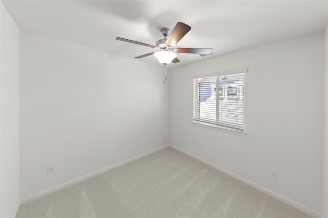 spare room with carpet and ceiling fan