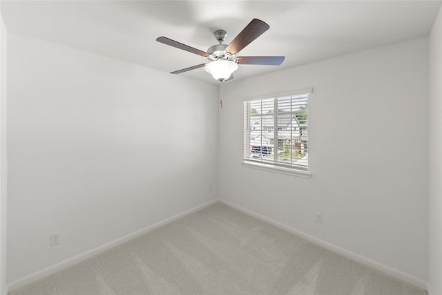 carpeted empty room featuring ceiling fan