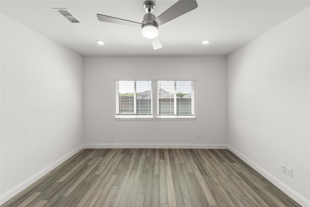 empty room featuring dark wood-type flooring and ceiling fan