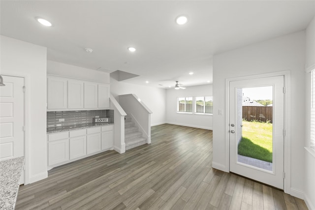 225 Griffith Dr, Princeton, TX 75407 - kitchen featuring white cabinetry, light stone counters, decorative backsplash, recessed lighting, and light wood-style floors