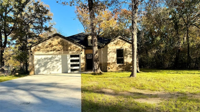 view of front of property with a front lawn and a garage