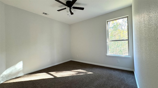 carpeted spare room with ceiling fan