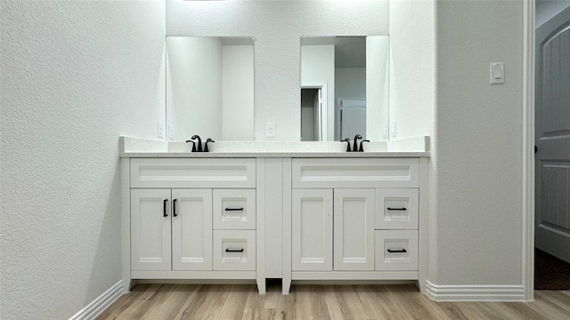 bathroom featuring hardwood / wood-style floors and vanity