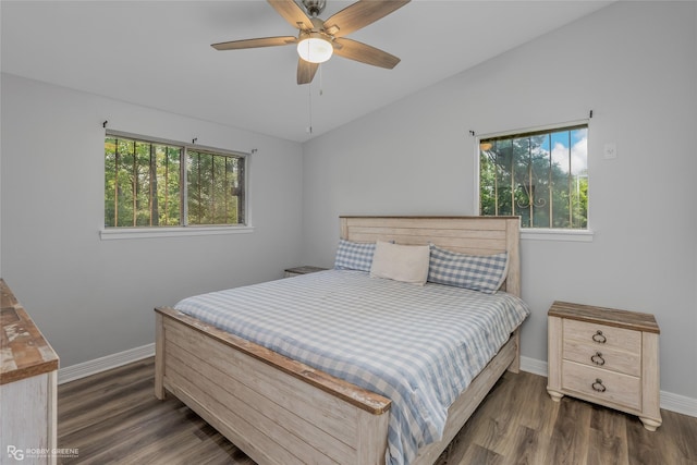 bedroom with ceiling fan, lofted ceiling, dark hardwood / wood-style flooring, and multiple windows