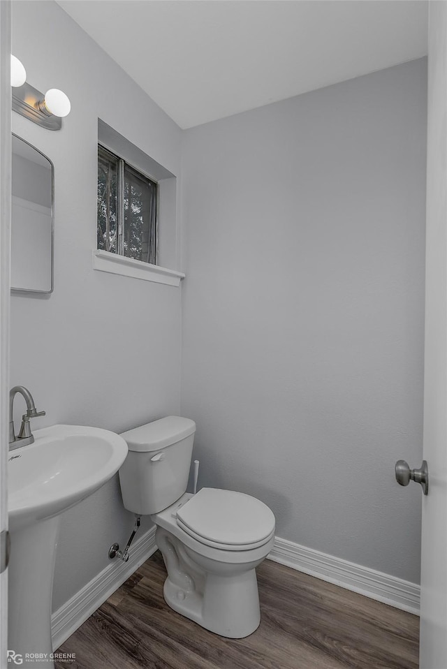 bathroom featuring sink, toilet, and hardwood / wood-style flooring