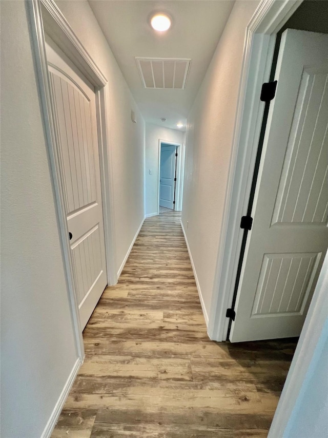 hall with light hardwood / wood-style flooring