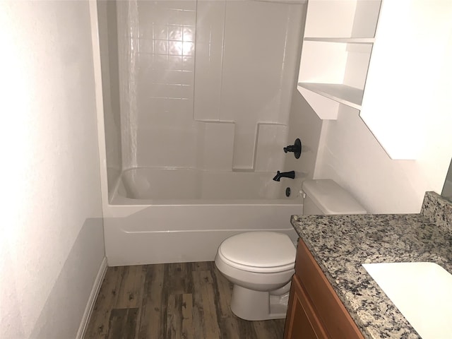 full bathroom with hardwood / wood-style floors, vanity, shower / bathtub combination, and toilet