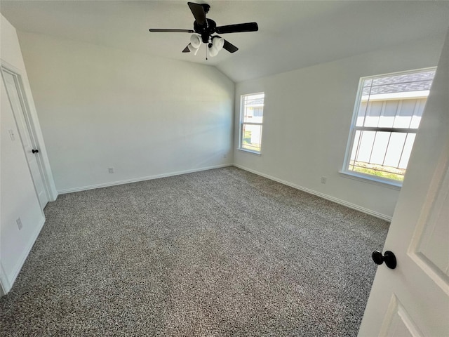 carpeted spare room featuring ceiling fan and vaulted ceiling