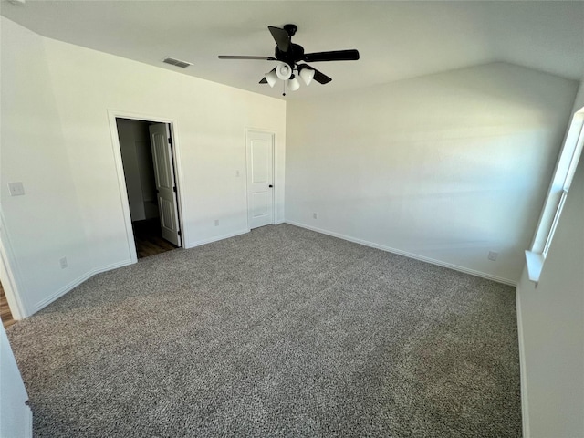 unfurnished bedroom featuring ceiling fan, dark carpet, and lofted ceiling