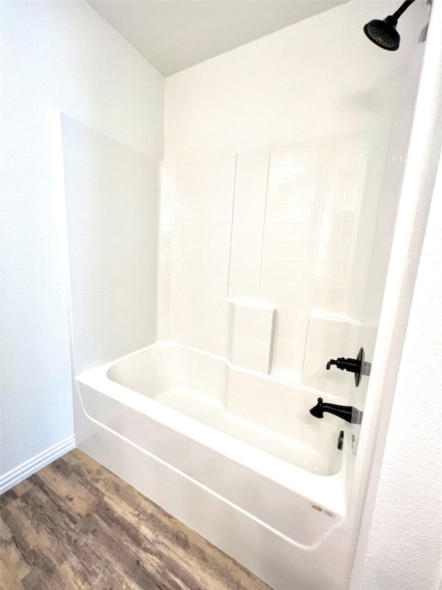 bathroom with shower / bathing tub combination and wood-type flooring