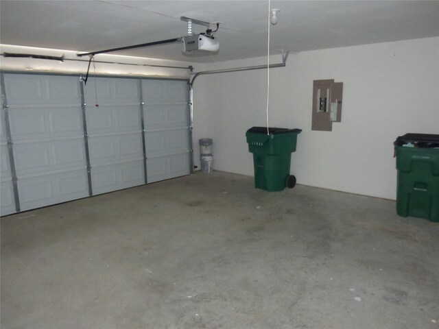 garage featuring electric panel and a garage door opener