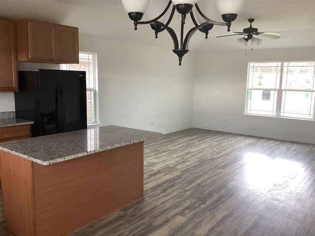 kitchen with black fridge, a healthy amount of sunlight, and dark hardwood / wood-style floors