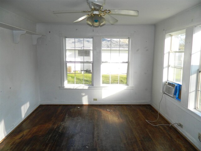 empty room featuring dark hardwood / wood-style floors, ceiling fan, and a healthy amount of sunlight