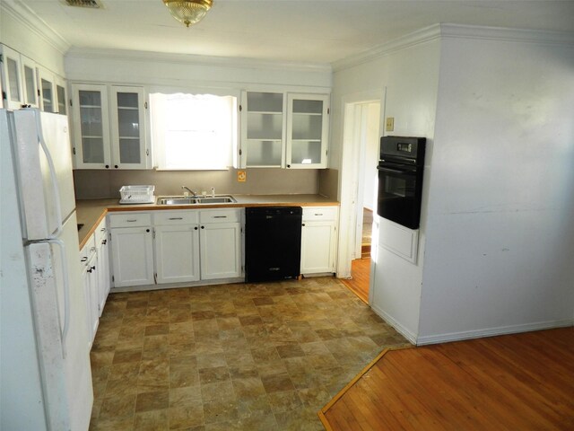 kitchen with white cabinetry, sink, wood-type flooring, black appliances, and ornamental molding