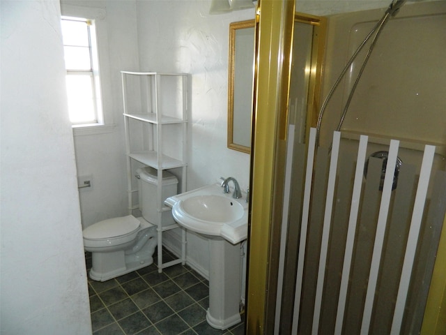 bathroom featuring toilet and walk in shower