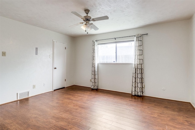 spare room with ceiling fan, hardwood / wood-style floors, and a textured ceiling