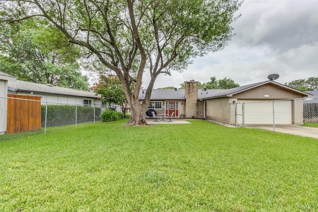 view of yard with a garage and a patio area