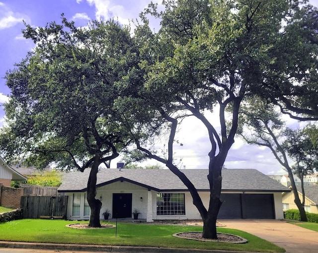 ranch-style house with a garage and a front lawn