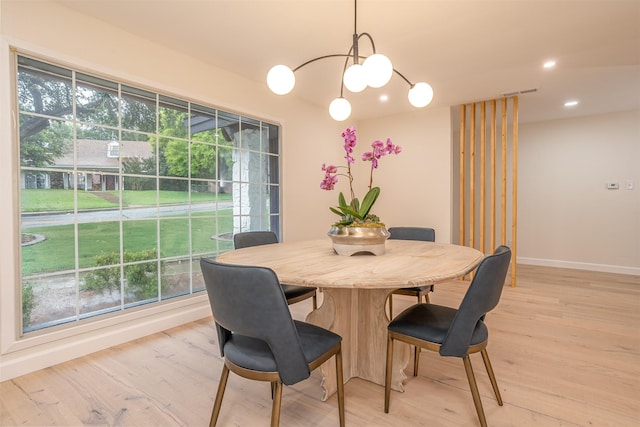 dining area with a healthy amount of sunlight and light hardwood / wood-style flooring