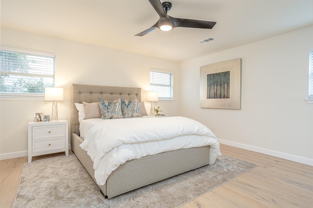 bedroom with light hardwood / wood-style floors and ceiling fan