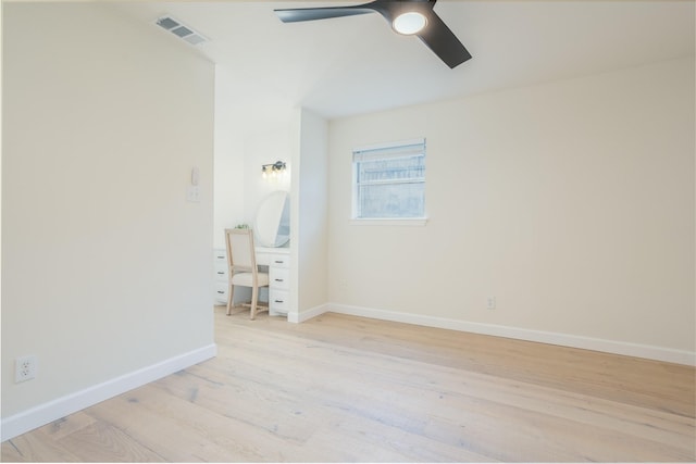 empty room with ceiling fan and light hardwood / wood-style floors