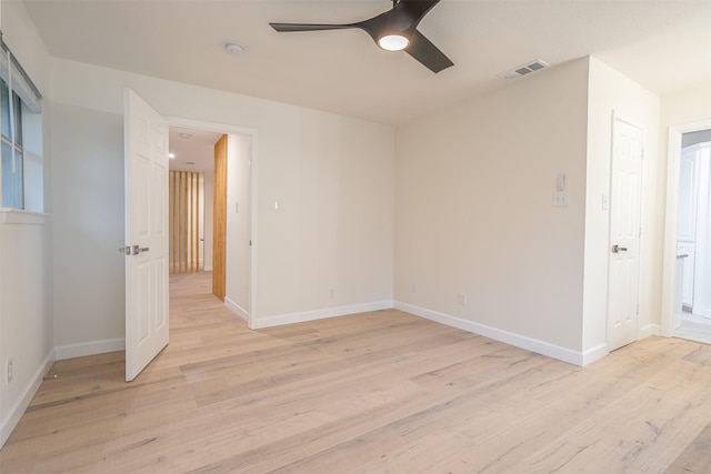 spare room with light wood-type flooring and ceiling fan