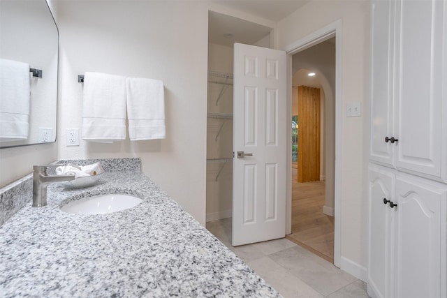 bathroom with vanity and wood-type flooring