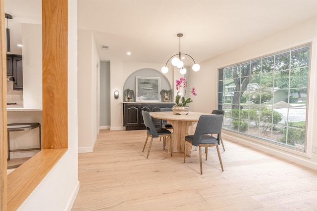 dining area featuring a healthy amount of sunlight and light hardwood / wood-style flooring