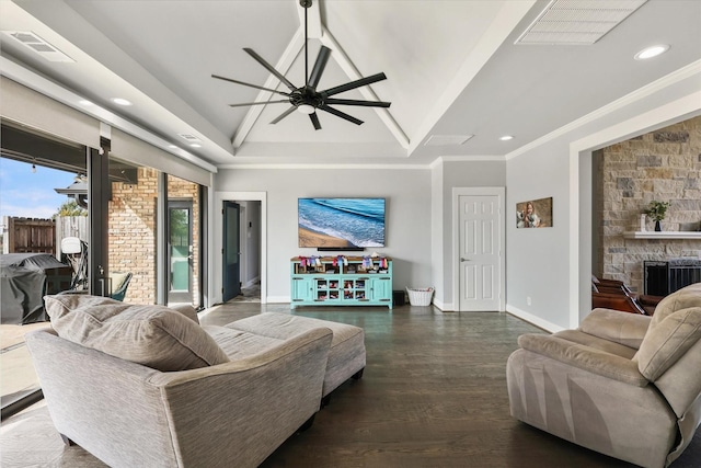 living room with a fireplace, dark hardwood / wood-style floors, ceiling fan, and ornamental molding