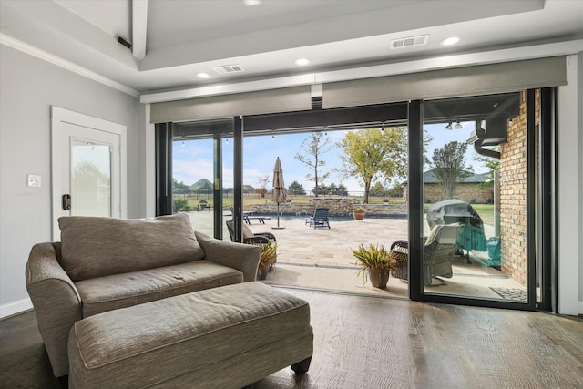 entryway featuring hardwood / wood-style floors and ornamental molding