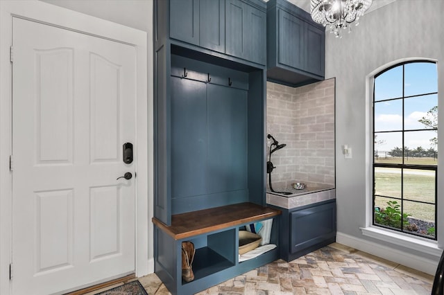 mudroom featuring a chandelier