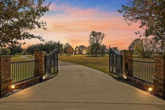 gate at dusk with a yard