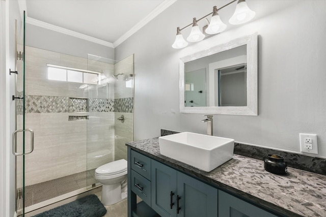 bathroom featuring vanity, toilet, an enclosed shower, and crown molding