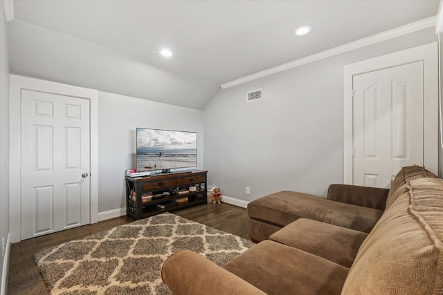 living room featuring dark hardwood / wood-style flooring, vaulted ceiling, and ornamental molding