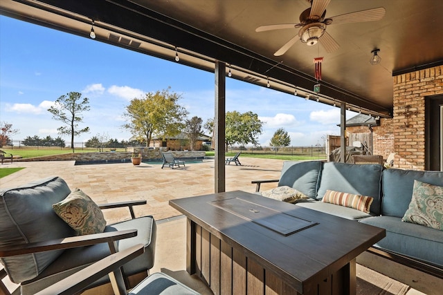 view of patio / terrace with outdoor lounge area, ceiling fan, and a pool