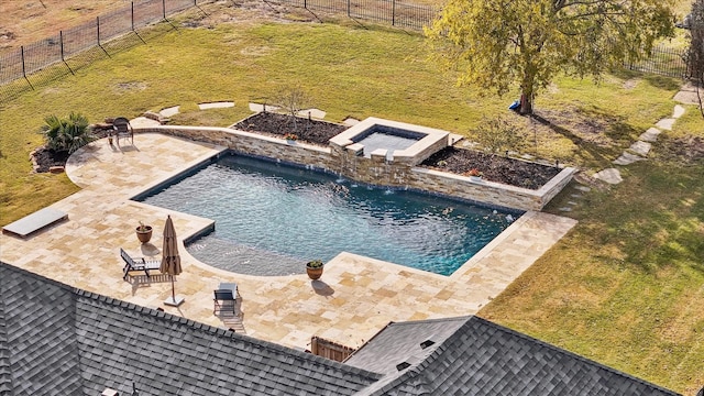 view of swimming pool featuring pool water feature, a yard, an in ground hot tub, and a patio