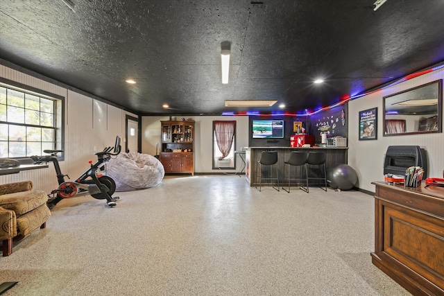 interior space with a textured ceiling and indoor bar