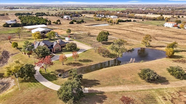 aerial view with a rural view and a water view